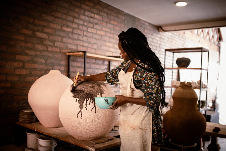 South African artist Zizipho Poswa hard at work on one of her clay 