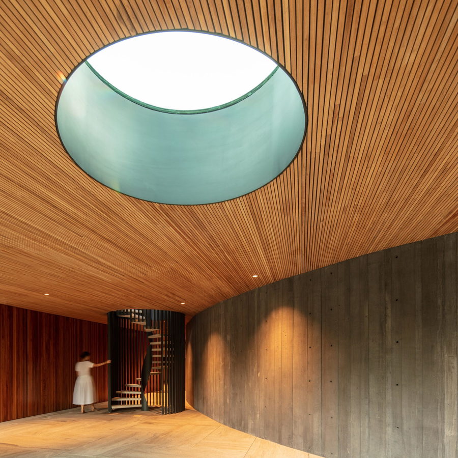 Spiral staircase and circular skylight inside the Bernardes Arquitetura-designed 