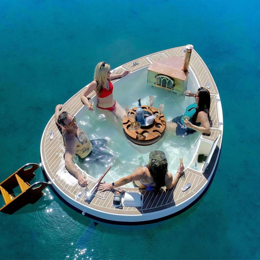 Overhead view of friends enjoying drinks on the lake from the comfort of the Spracuzzi.