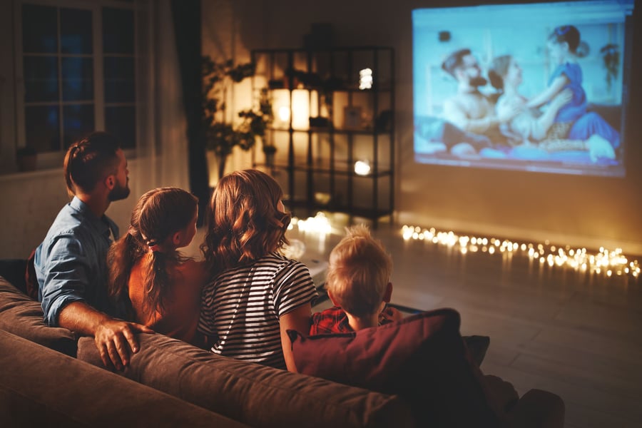 Family snuggles up and watches a movie for Christmas.