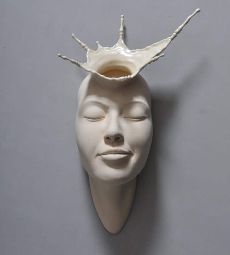 Surreal ceramic by Johnson Tsang shows the top of a face splashing out like liquid.