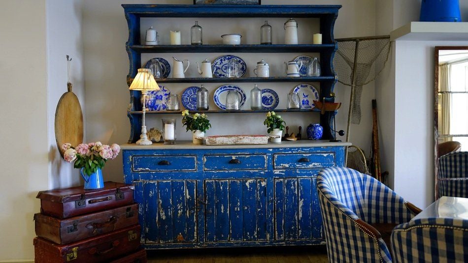 Intentionally distressed furniture like this gorgeous blue dresser is a super popular feature of shabby chic decorating.