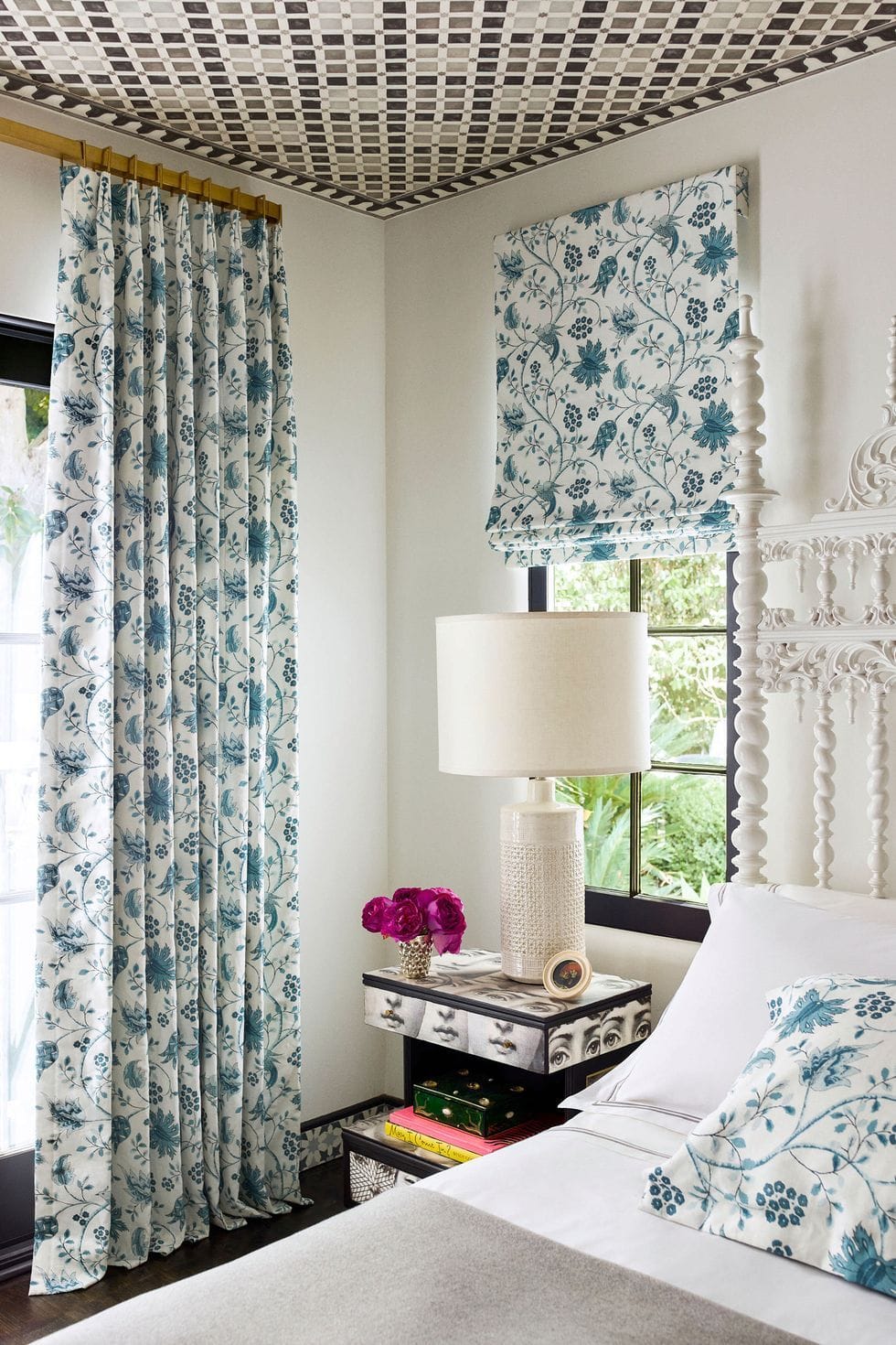 Patterned curtains and bedding in this bedroom help give it a vibrant contemporary flair.