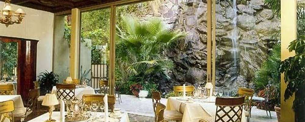 Dining Room with 50-foot waterfall in the background Dining Room with 50-foot waterfall in the background