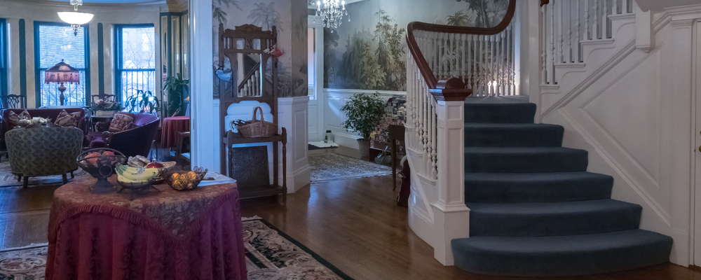 The interior foyer, main stairway, lobby & parlor area.