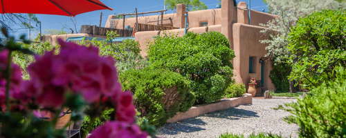 Massive adobe pueblo compound provides an authentic historic Santa Fe accommodation experience in downtown Santa Fe.