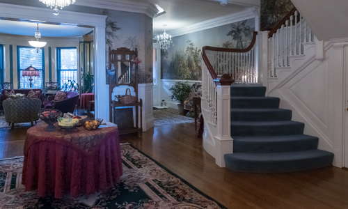 The interior foyer, main stairway, lobby & parlor area.
