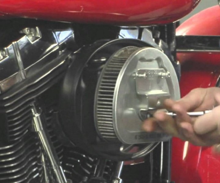 Remove the air filter from the cleaner assembly to access the breather bolt