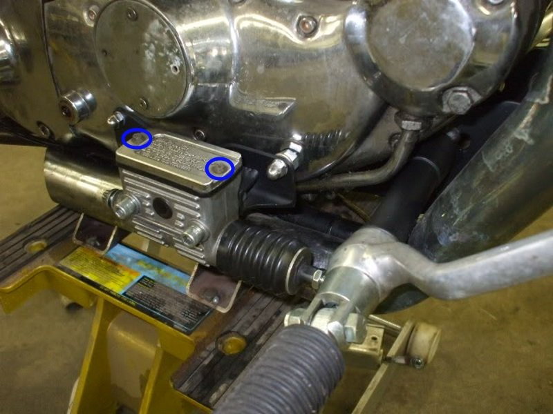 Location of rear master cylinder cover bolts on Sportster