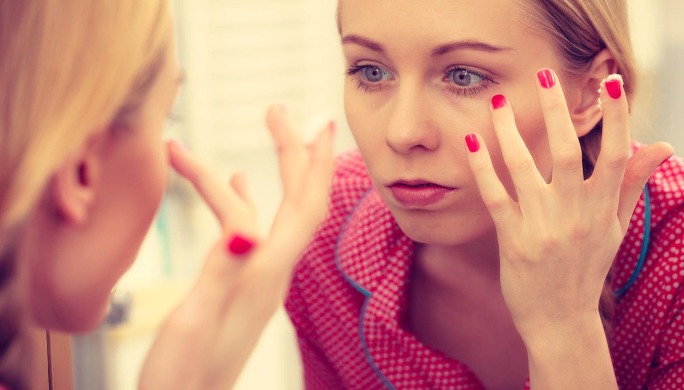 woman applying moisturizer