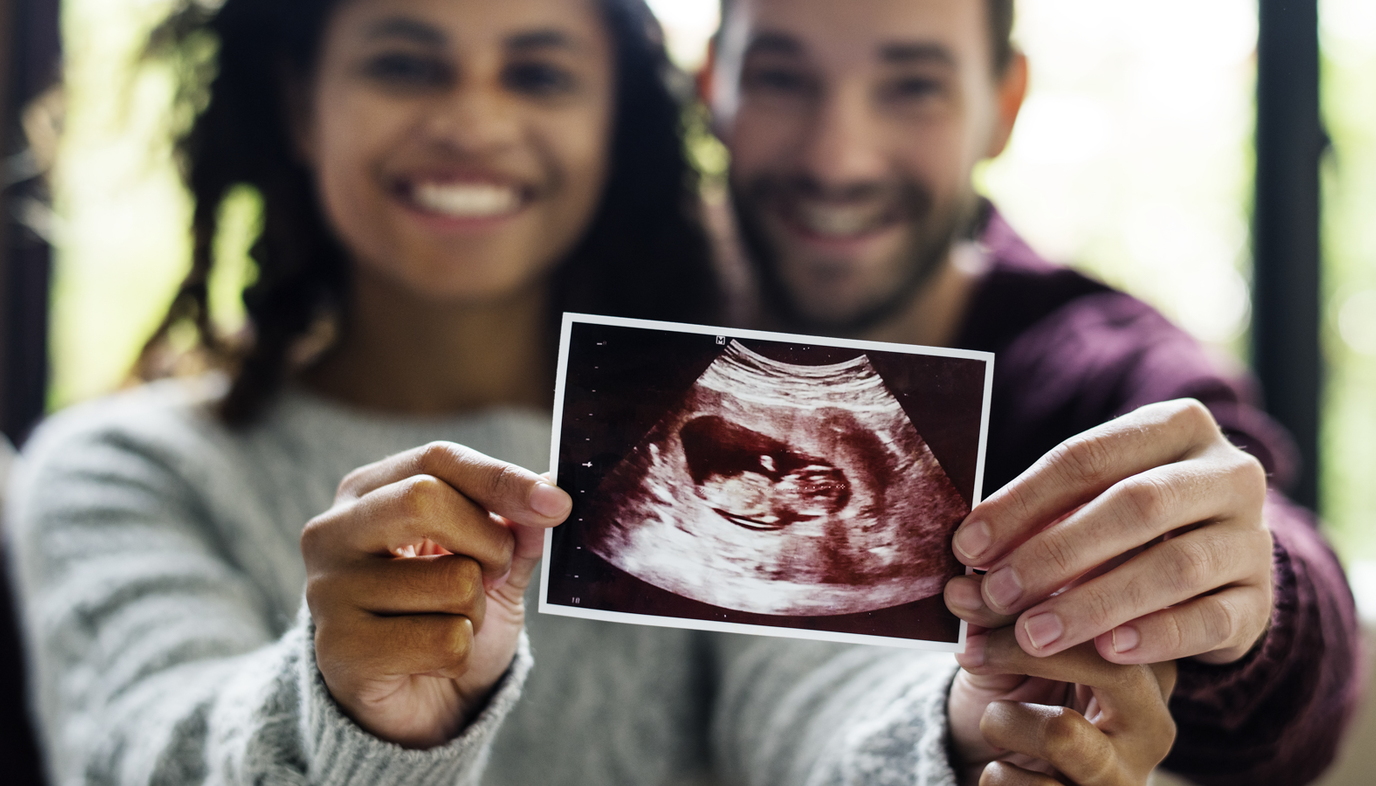 couple holding ultrasound picture
