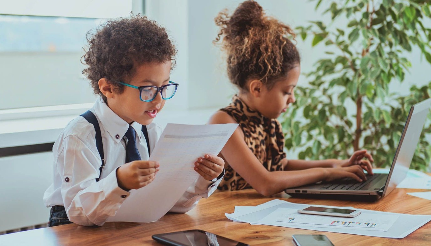 children dressed up like little adults in an office