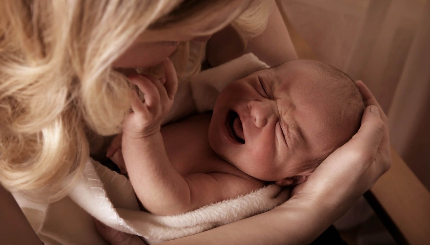 mom holding new baby