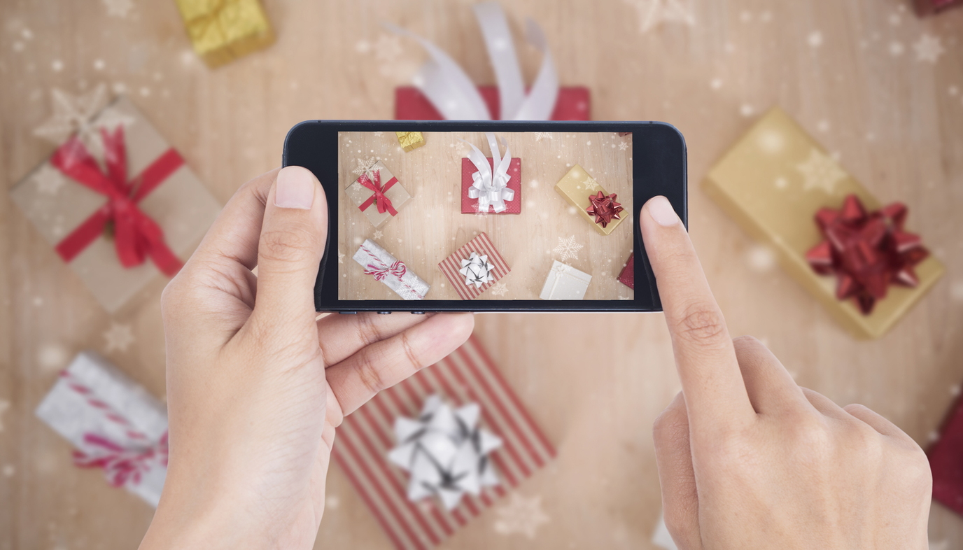 mom taking photo of Christmas presents with smartphone
