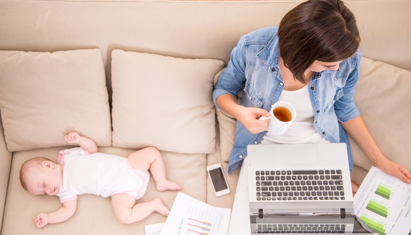 mom working at home with baby nearby