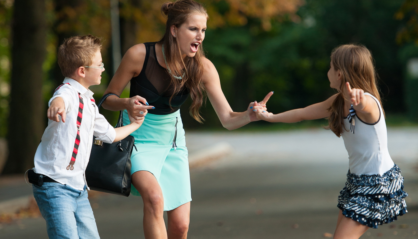 mother scolding children at park