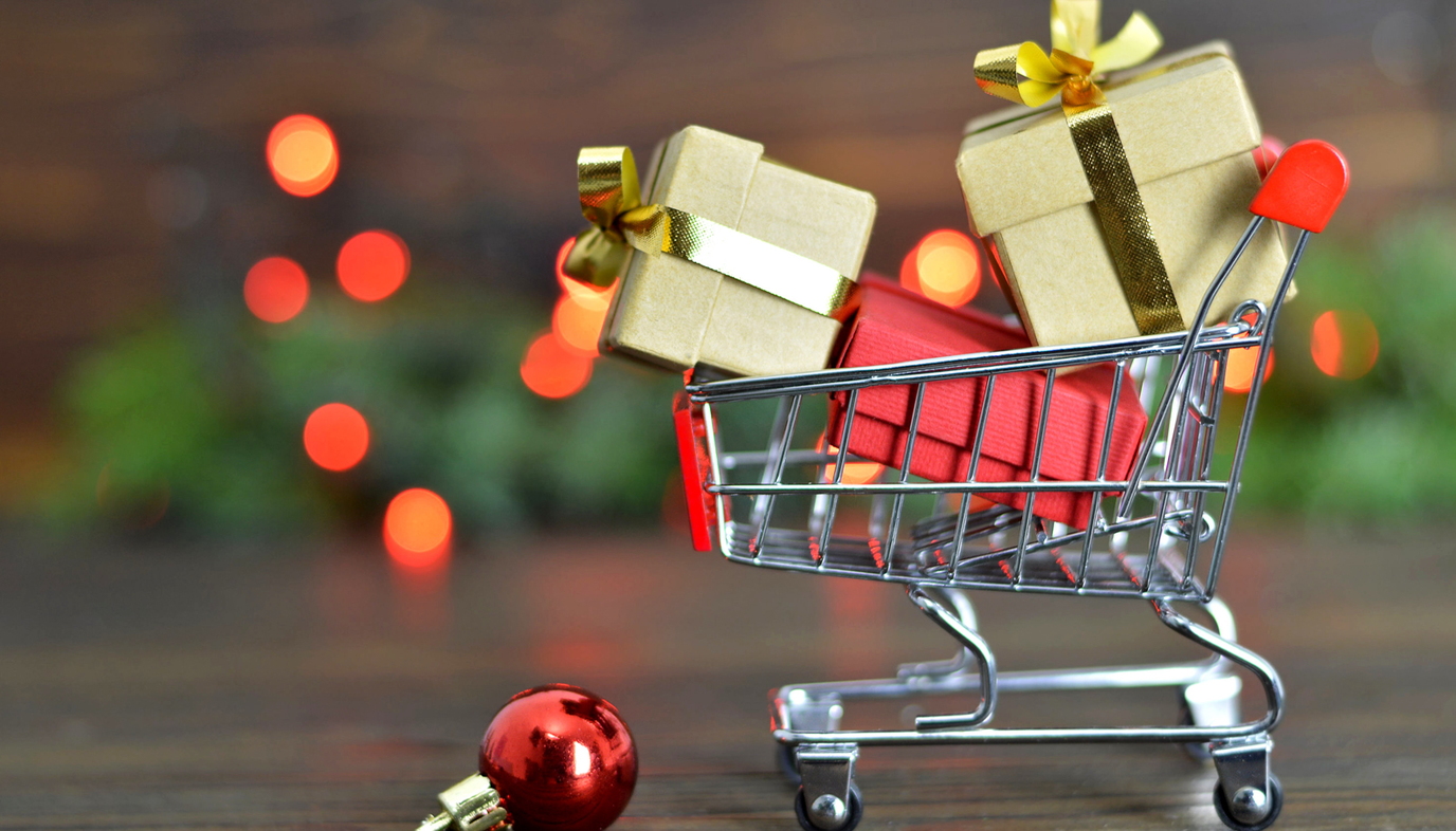 minature shopping cart with Christmas presents in it