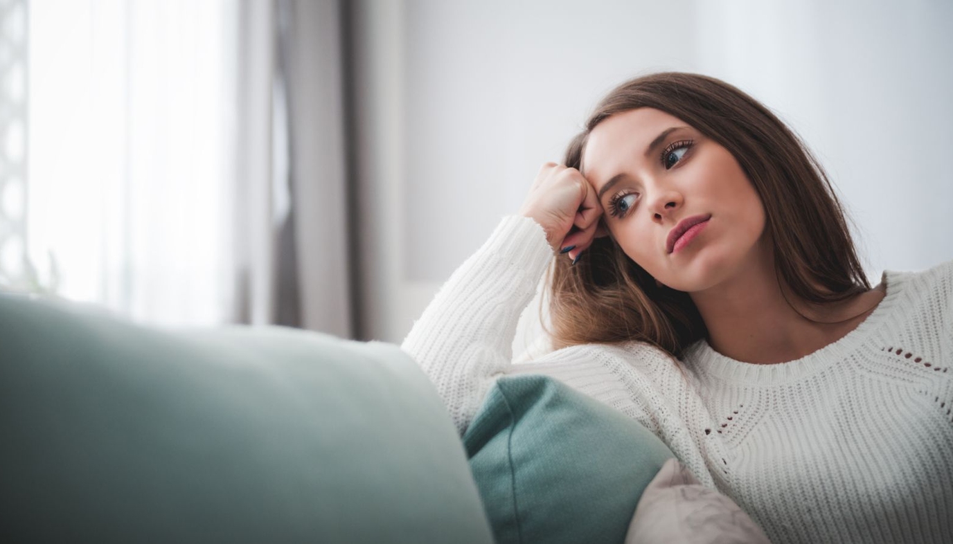 sad woman sitting on the couch