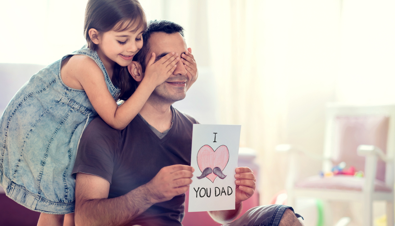 daughter surprising dad with Father's Day card