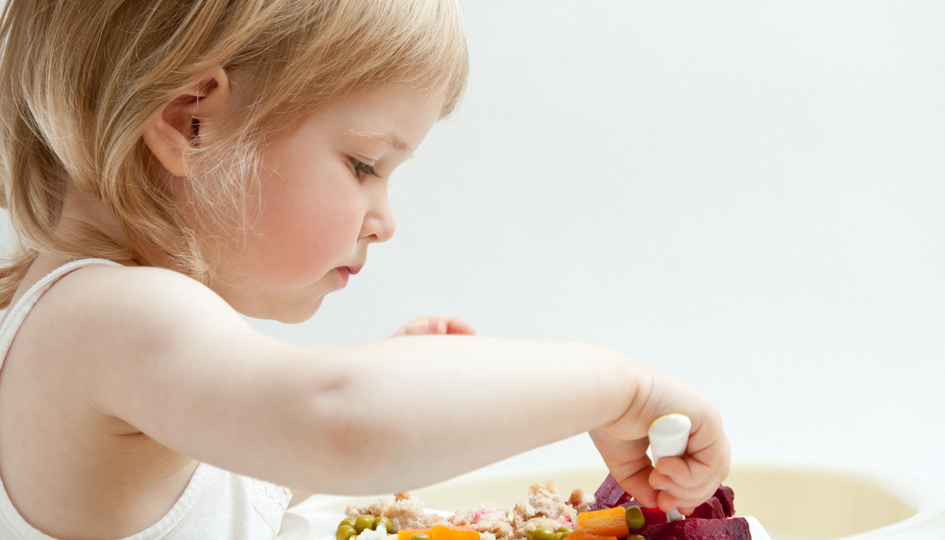 child eating vegetables