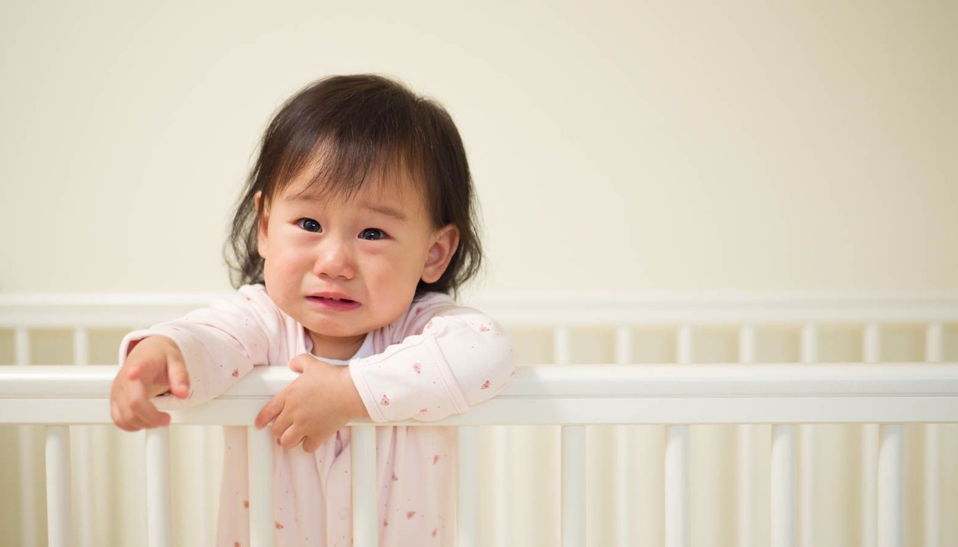 baby standing in crib