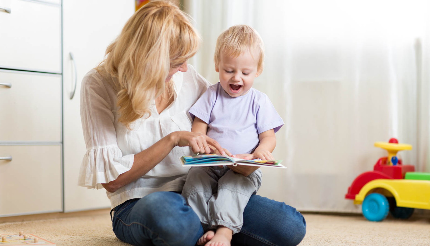 mom reading book to toddler