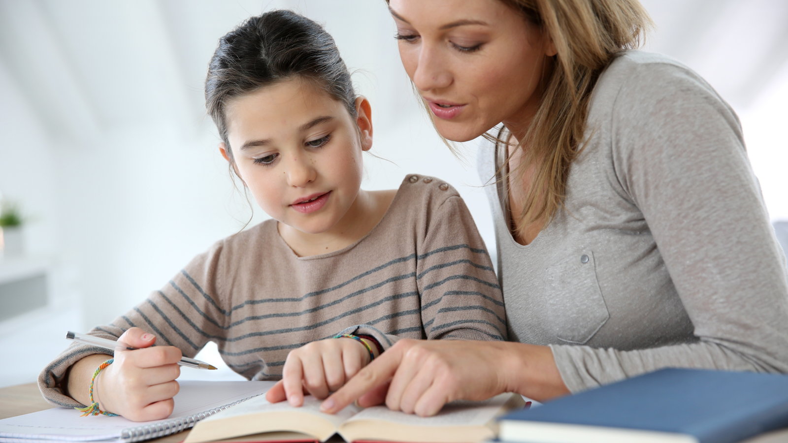 mom helping daughter with homework