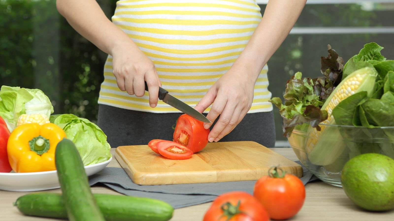 pregnant mom cutting up vegetables