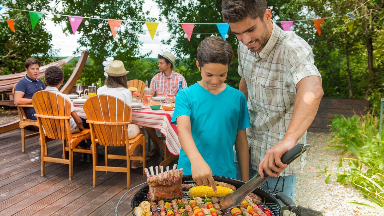 dad and son cooking on the grill