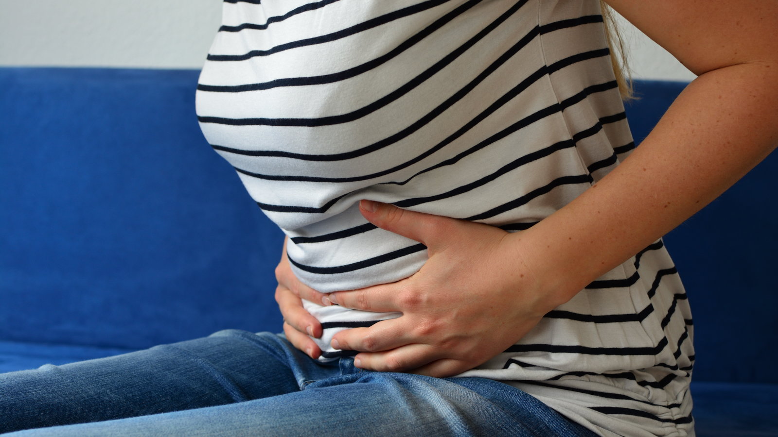 pregnant woman grabbing her stomach