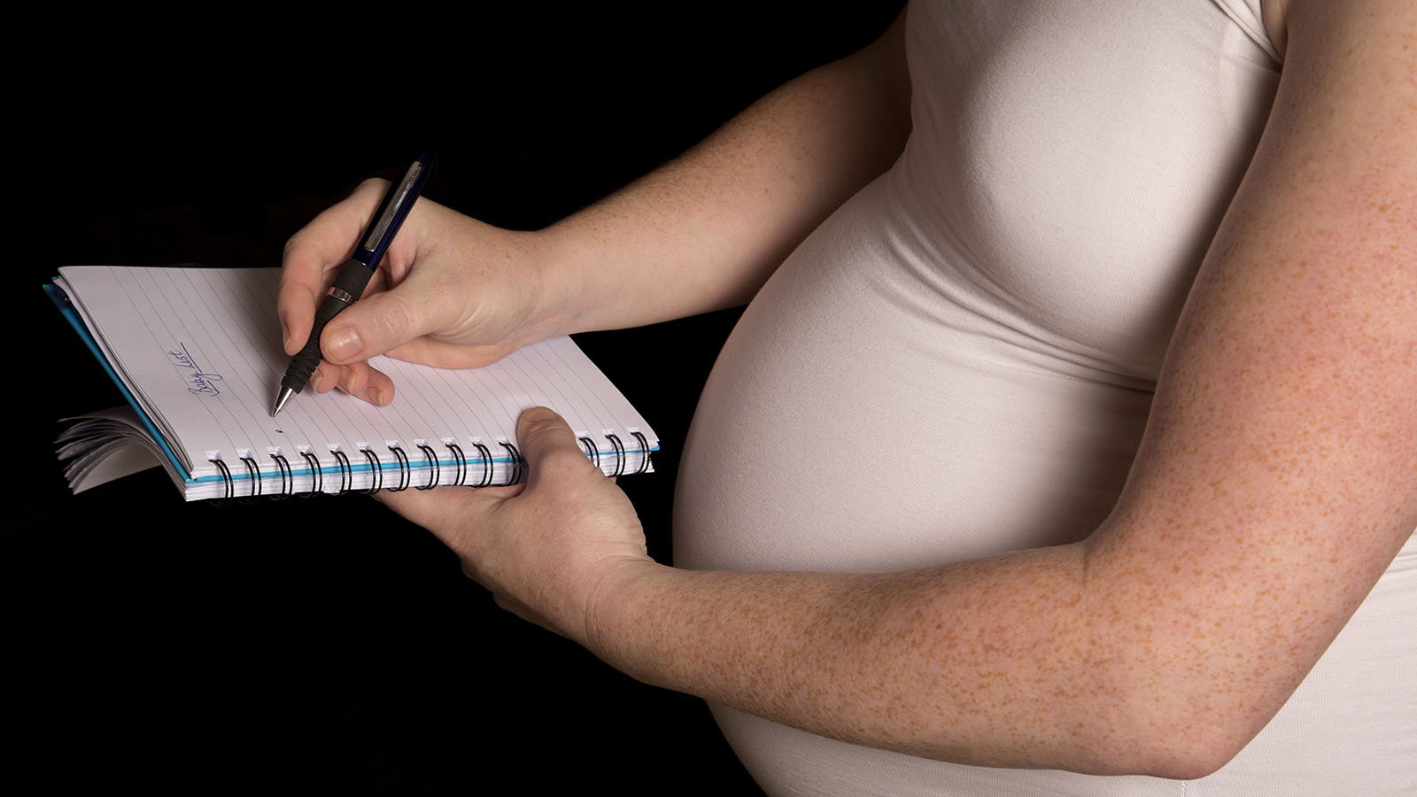 pregnant woman writing list