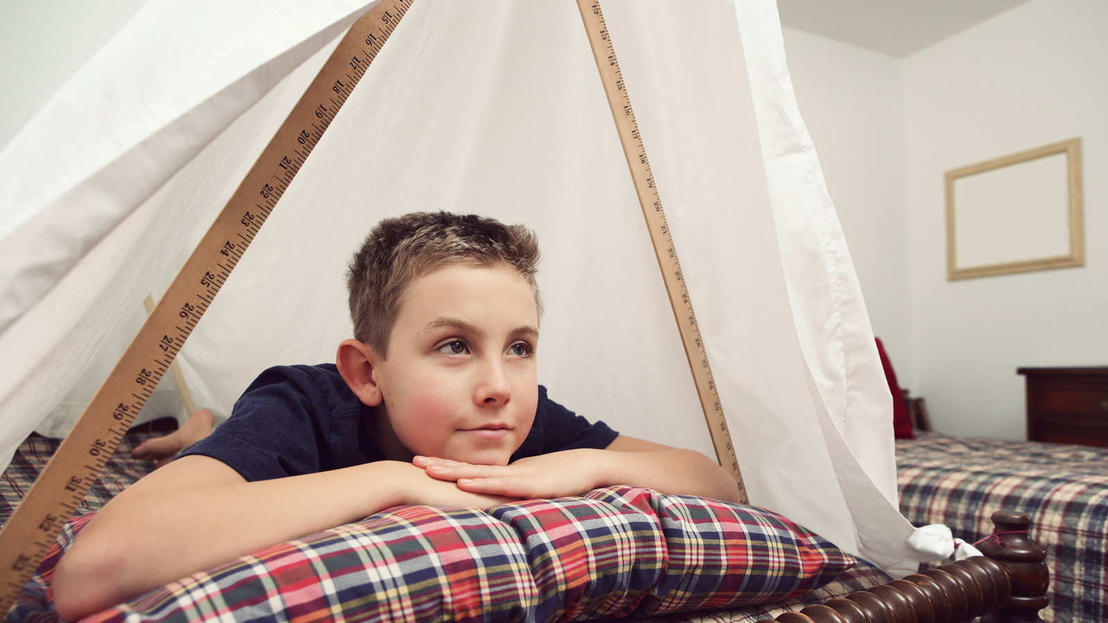 child in homemade fort
