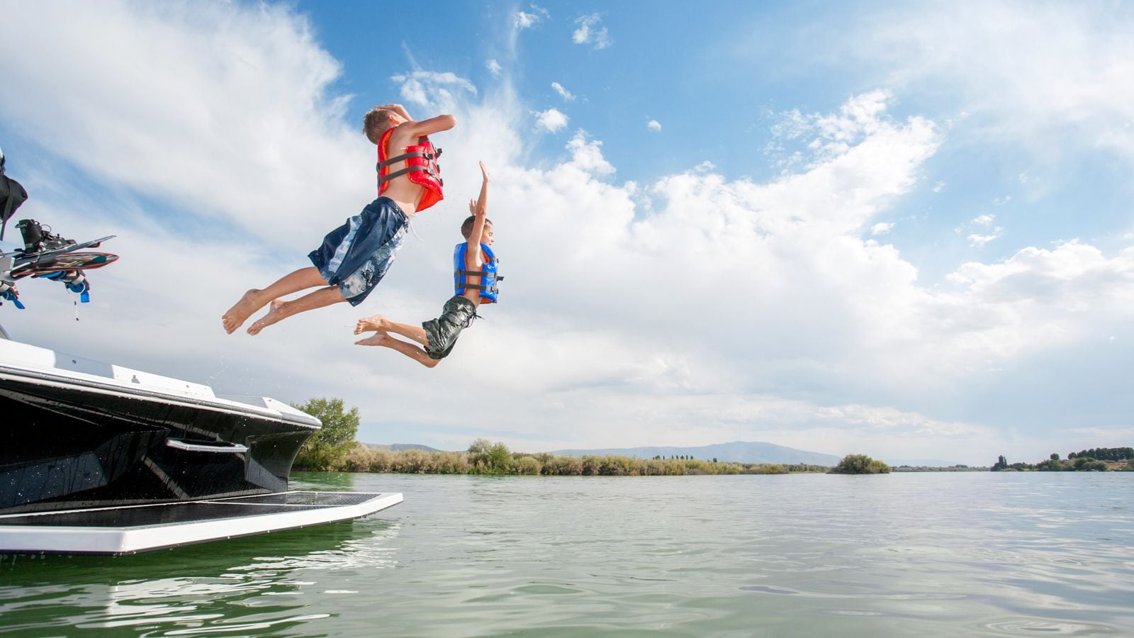 kids jumping into lake