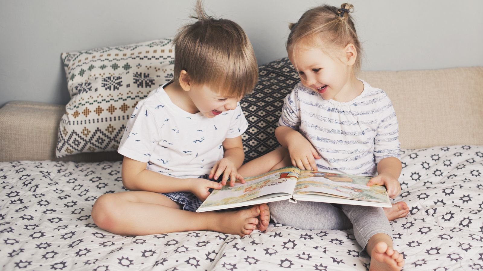 toddlers reading a book together