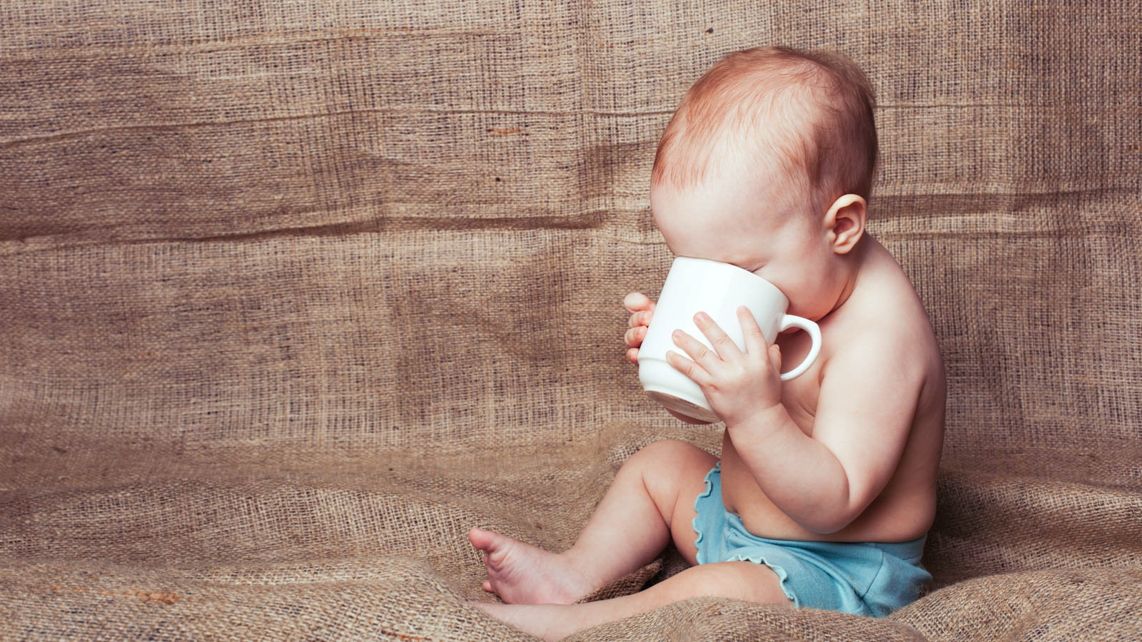 baby drinking out of mug