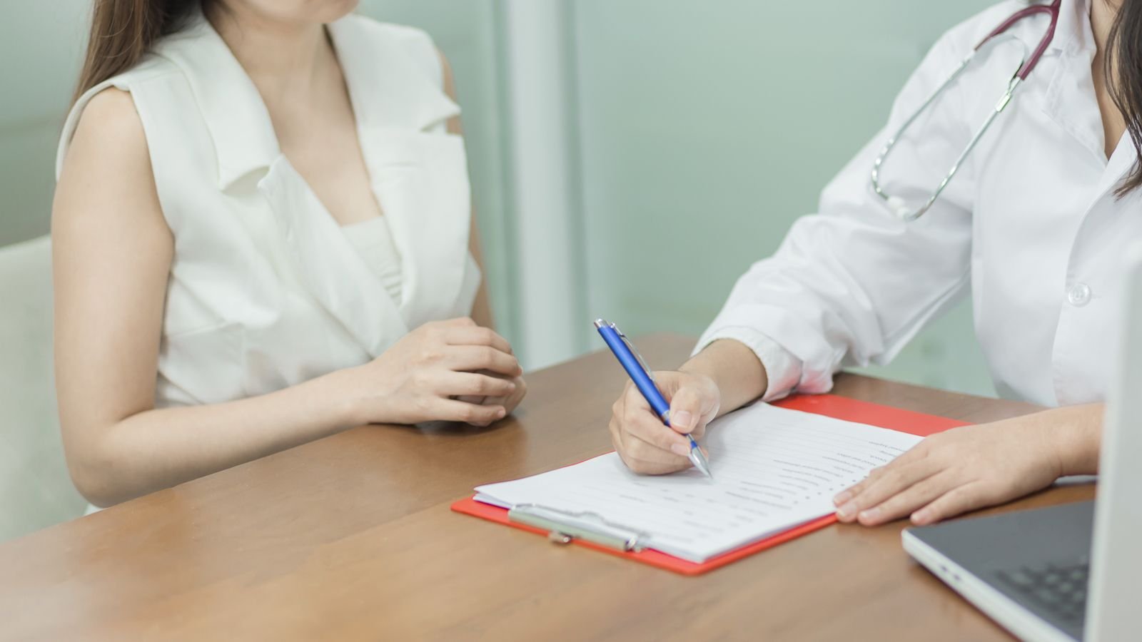 woman talking to a doctor