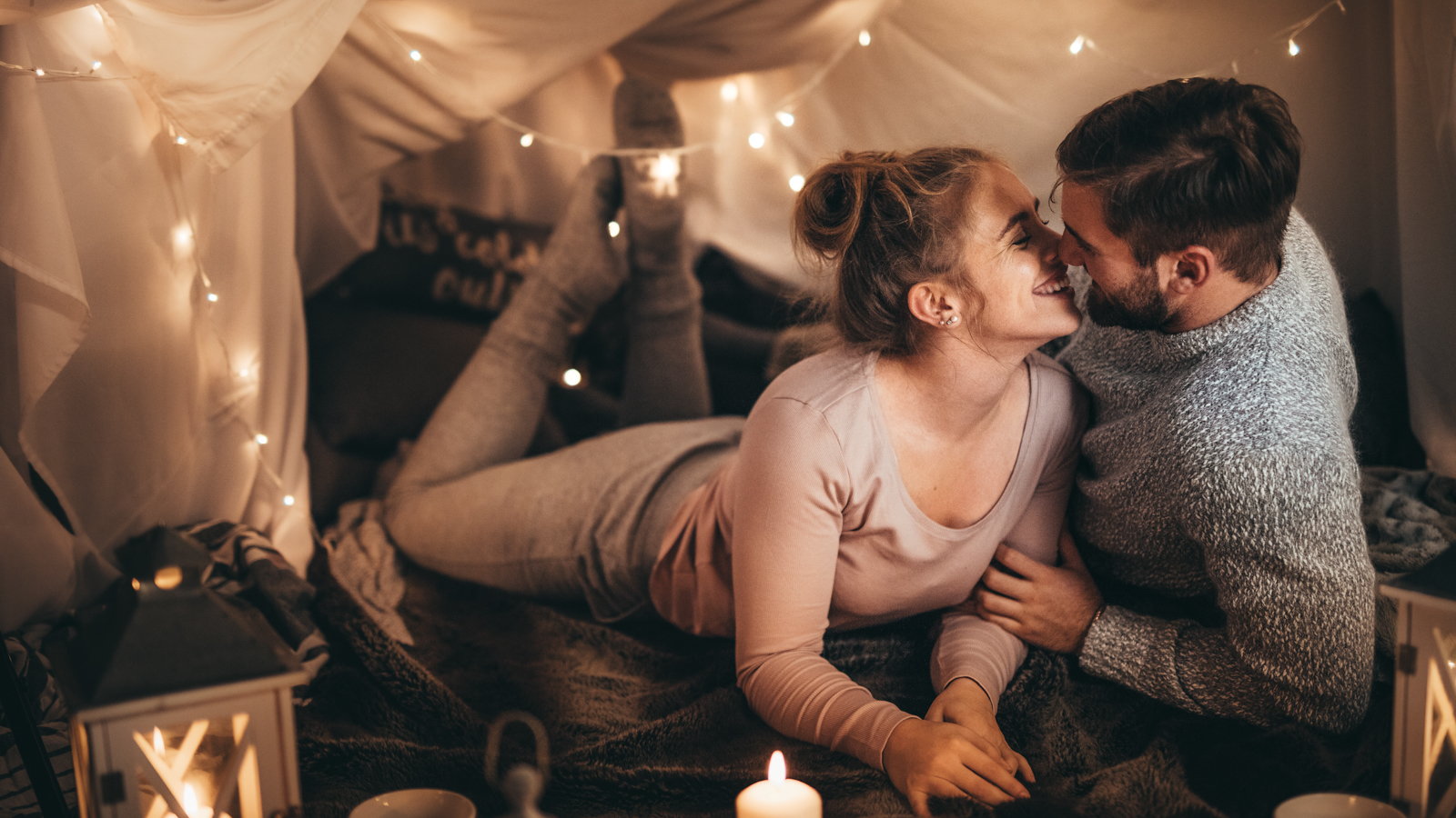 couple having a romantic night in bedroom fort