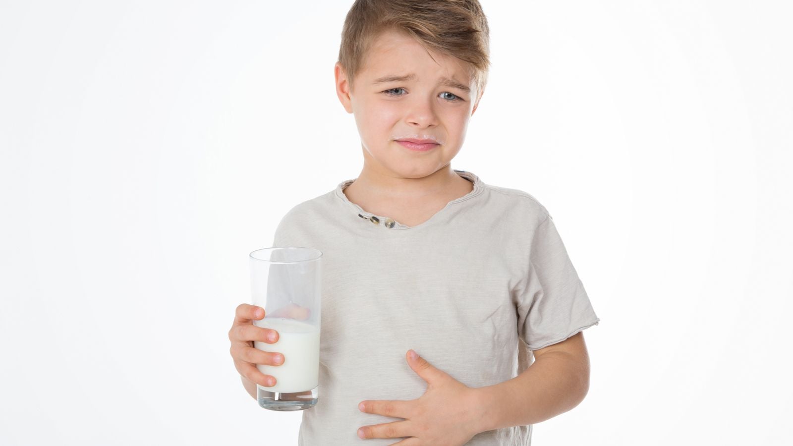 Boy drinking milk with stomachache