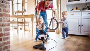 dad vacuuming with kids