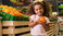 girl selecting vegetable from the grocery store