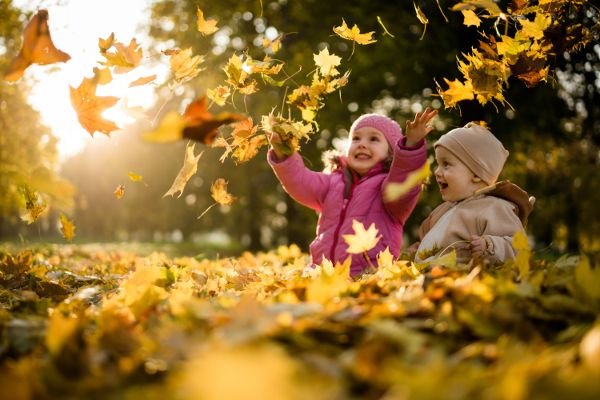 kids playing in leaves