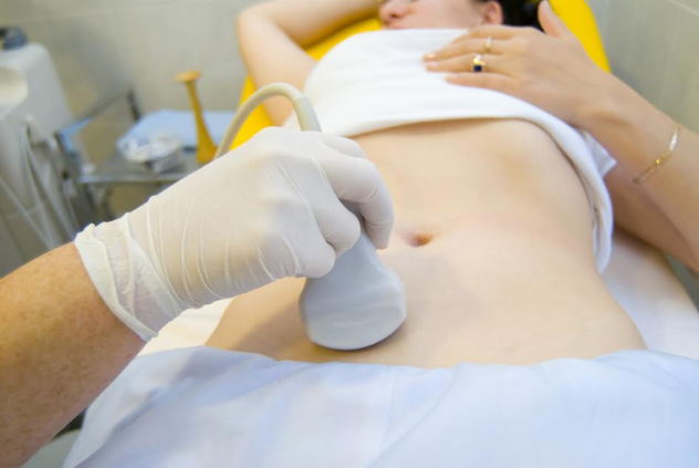 A woman getting a sonogram. 