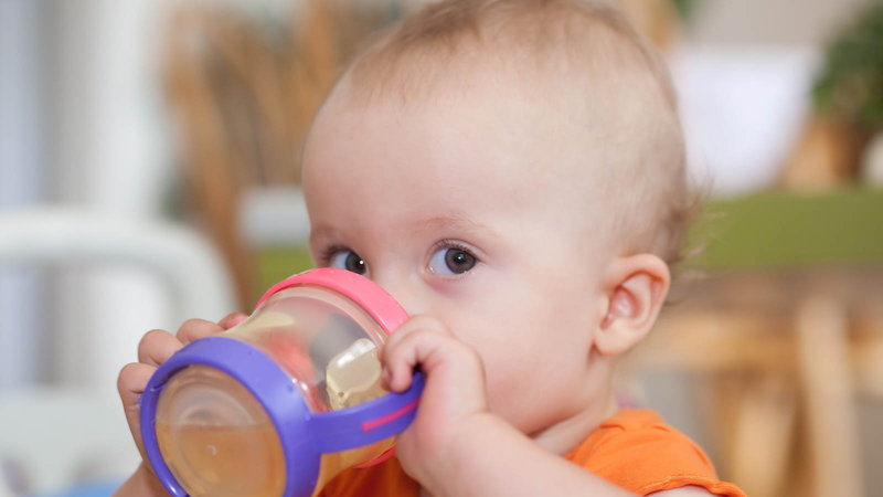 baby drinking from sippy cup