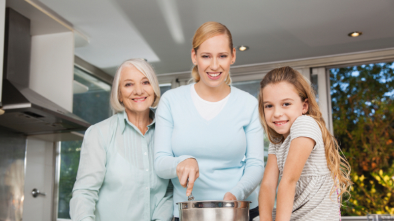 Mom, daughter, and grandma cooking in a kitchen
