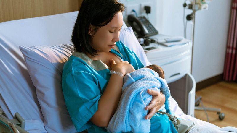 Mother breastfeeding baby in the hospital