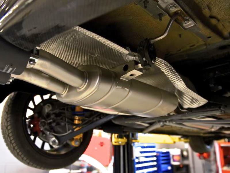 Remove the rubber insulators from the sides of the muffler
