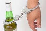alcoholic handcuffed to a bottle of liquor