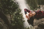 emotionally free woman laying near waterfall