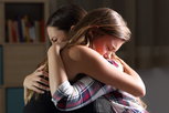 Friends hug as one seeks support and recovery following a sexual assault