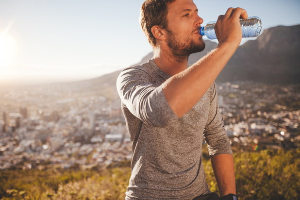 man drinking water to stay hydrated